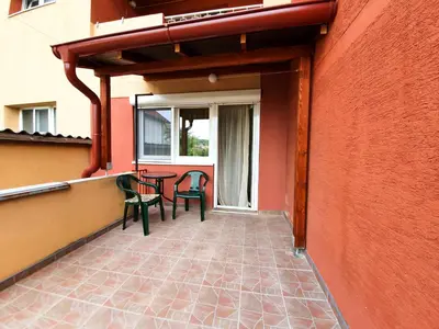 a patio with chairs and a table on a building at Smestaj Katarina in Soko Banja
