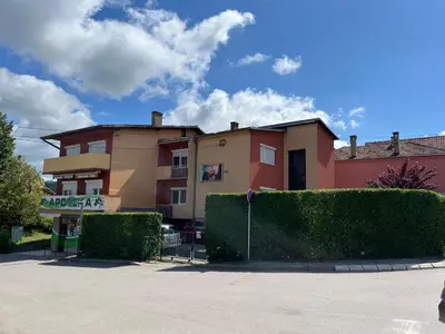 a building with bushes in front of a building at Smestaj Katarina in Soko Banja