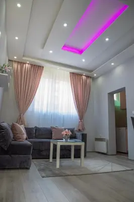 a living room with a couch and a table at DIS apartman 1 in Kruševac