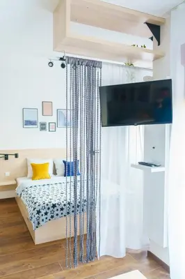 a bedroom with a bed and a flat screen tv at Apartments Karamarković 1 in Vrnjačka Banja