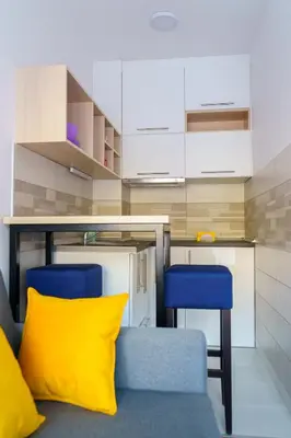 a living room with a couch and two blue chairs at Apartments Karamarković 1 in Vrnjačka Banja