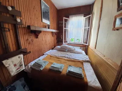 a small room with two beds and a window at Garičkina kuća in Pirot