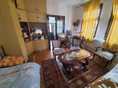 a living room with a table and chairs at Garičkina kuća in Pirot