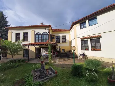 a large white house with a yard in front of it at Garičkina kuća in Pirot