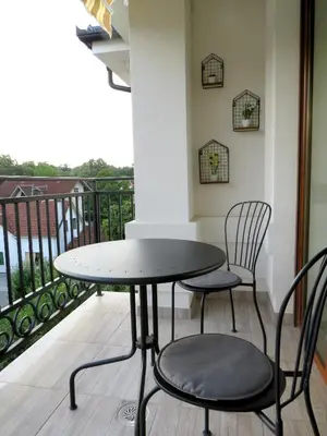 a table and two chairs on a balcony at Sunset Vrnjačka Banja in Vrnjačka Banja