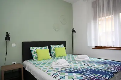 a bedroom with a bed with towels on it at Sneznik Palace in Vrnjačka Banja
