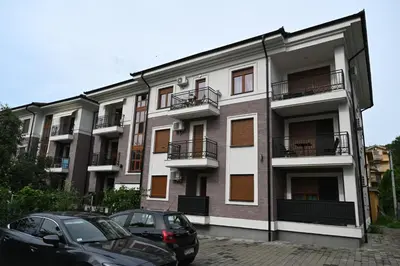 two cars parked in front of a building at Sneznik Palace in Vrnjačka Banja
