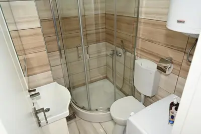 a bathroom with a toilet and a shower at Sneznik Palace in Vrnjačka Banja