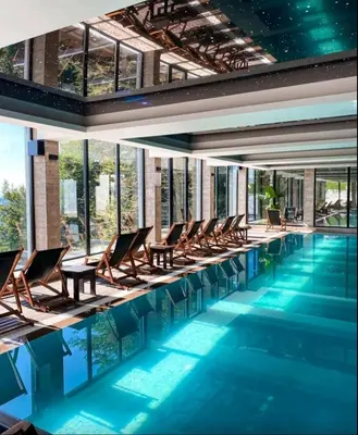 a swimming pool with lounge chairs and a swimming pool at Vistanova Milmari S33 in Kopaonik