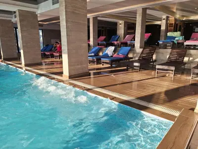 a pool in a hotel with chairs and a swimming pool at Vistanova Milmari S33 in Kopaonik