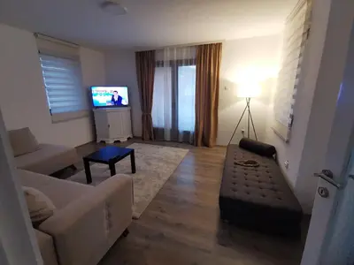a living room with a couch and a television at Apartman Centar in Aleksandrovac