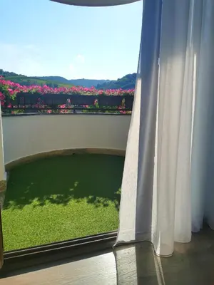 a window with a view of a green field at Apartman Centar in Aleksandrovac