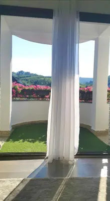 a white curtain in a room with a window at Apartman Centar in Aleksandrovac
