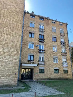 a large brick building with a large window at Apartment 13 in Vrnjačka Banja