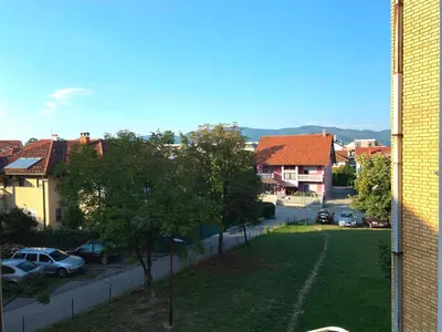 a view of a residential neighbourhood with cars parked on a street at Apartment 13 in Vrnjačka Banja