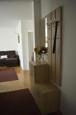 a living room with a wooden cabinet in a room at Apartman Pirot in Pirot