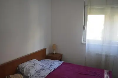 a bedroom with a bed and a window at Apartman Pirot in Pirot