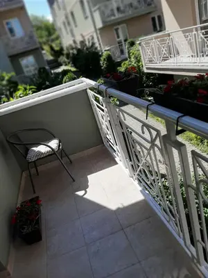a balcony with a chair and some plants at Apartman OAZA in Vrnjačka Banja