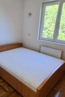 a large bed in a room with a window at Apartman u Brzecu - Kopaonik in Kopaonik