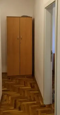 a room with a wooden floor and a cabinet at Apartman u Brzecu - Kopaonik in Kopaonik