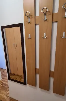 a row of wooden doors and a mirror on a wall at Apartman u Brzecu - Kopaonik in Kopaonik