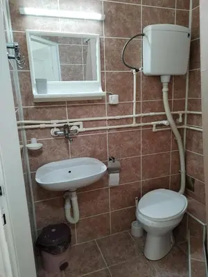 a bathroom with a toilet and a sink and a mirror at Studio Andrijana Sokobanja in Soko Banja