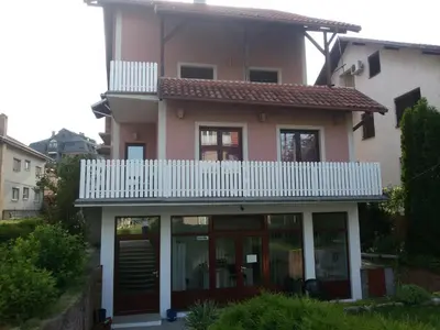 a house with a white balcony on top of it at Studio Andrijana Sokobanja in Soko Banja