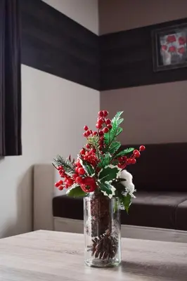 a vase with red and white flowers on a table at Milmari Friends and Family in Kopaonik