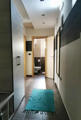 a hallway with a blue rug on the floor at Milmari Friends and Family in Kopaonik