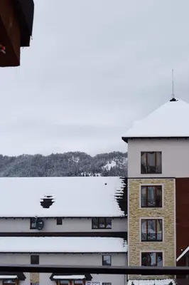 a building with snow on the roof at Milmari Friends and Family in Kopaonik