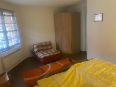 a bedroom with a bed and a chair in it at Vila Panic in Pirot