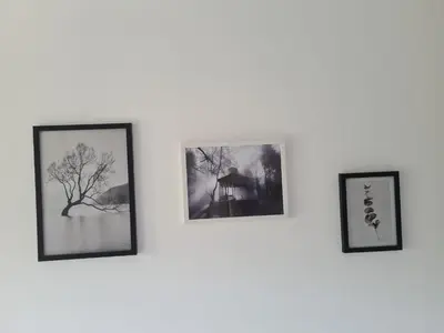 three framed photographs hanging on a white wall at Green door 2 in Vrnjačka Banja