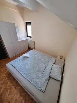 a small bedroom with a bed and a window at Green door 2 in Vrnjačka Banja