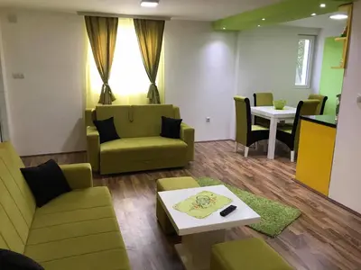 a waiting room with a couch and a table at Studio Ivana 2 in Soko Banja
