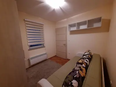 a small room with a couch and a window at Apartman Ana in Vrnjačka Banja