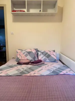 a bed with two pillows on top of it at Apartman Ana in Vrnjačka Banja
