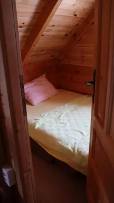a small room with a bed in a attic at Vikendice Mijajlović 1 in Kuršumlija