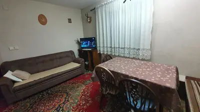 a living room with a couch and a table at Kuća za odmor Virtus Goč in Vrnjačka Banja