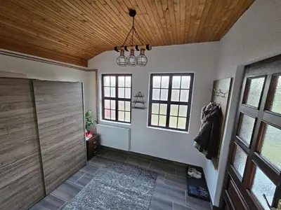 a large bathroom with a shower and a wooden ceiling at Kuća za odmor Virtus Goč in Vrnjačka Banja
