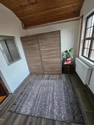 a room with a sliding door and a rug at Kuća za odmor Virtus Goč in Vrnjačka Banja