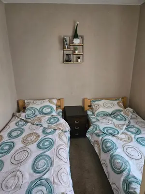 two beds sitting next to each other in a bedroom at Kuća za odmor Virtus Goč in Vrnjačka Banja