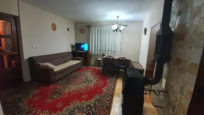 a living room with a couch and a red rug at Kuća za odmor Virtus Goč in Vrnjačka Banja