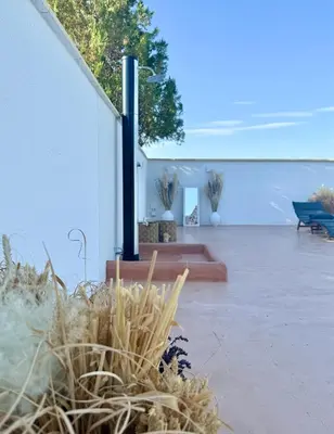 a courtyard with plants and a white building at House Milovanovic in Soko Banja