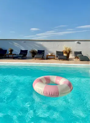 a swimming pool with a pink and white raft in the water at House Milovanovic in Soko Banja