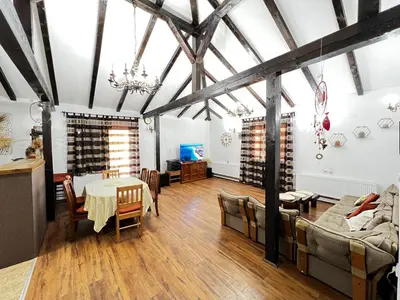 a large living room with a table and a couch at House Milovanovic in Soko Banja