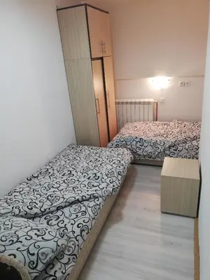 a room with two beds and a cabinet at NOV-dve spavaće sobe in Kopaonik