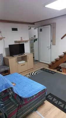 a living room with a bed and a tv at NOV-dve spavaće sobe in Kopaonik