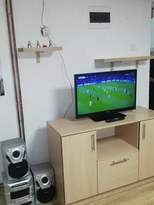 a television sitting on top of a wooden cabinet at NOV-dve spavaće sobe in Kopaonik