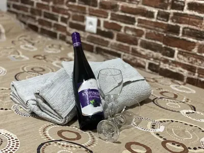 a bottle of wine sitting on a table with a glass at Apartman Urosevic in Jagodina