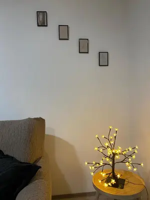 a table with a small tree with lights on it at Apartman Urosevic in Jagodina